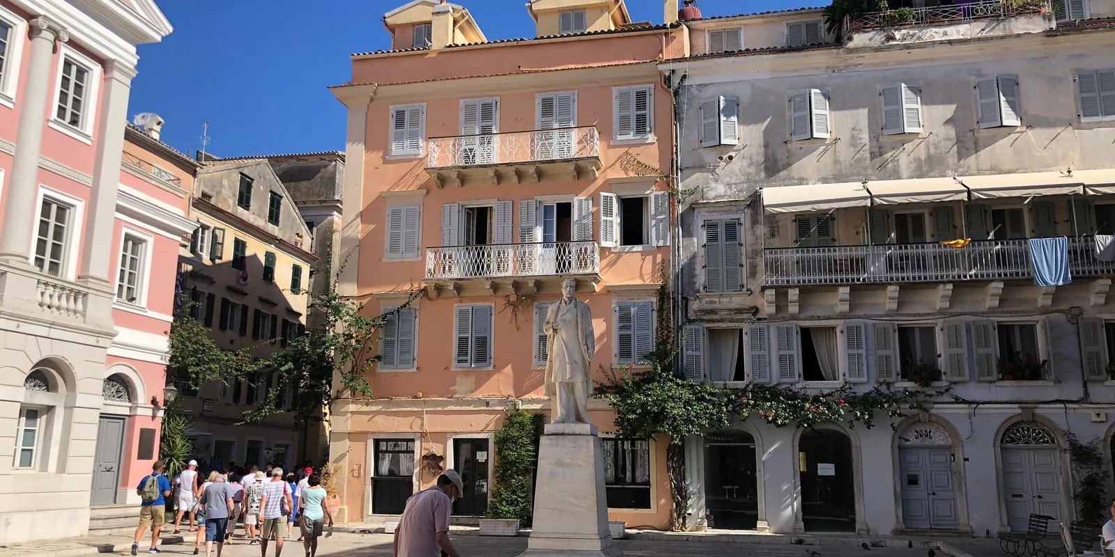 People walking in a historic square in Corfu Town