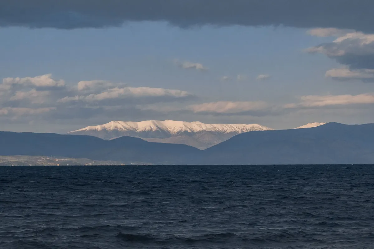 View from Corfu across the sea to snow-capped mountains in winter