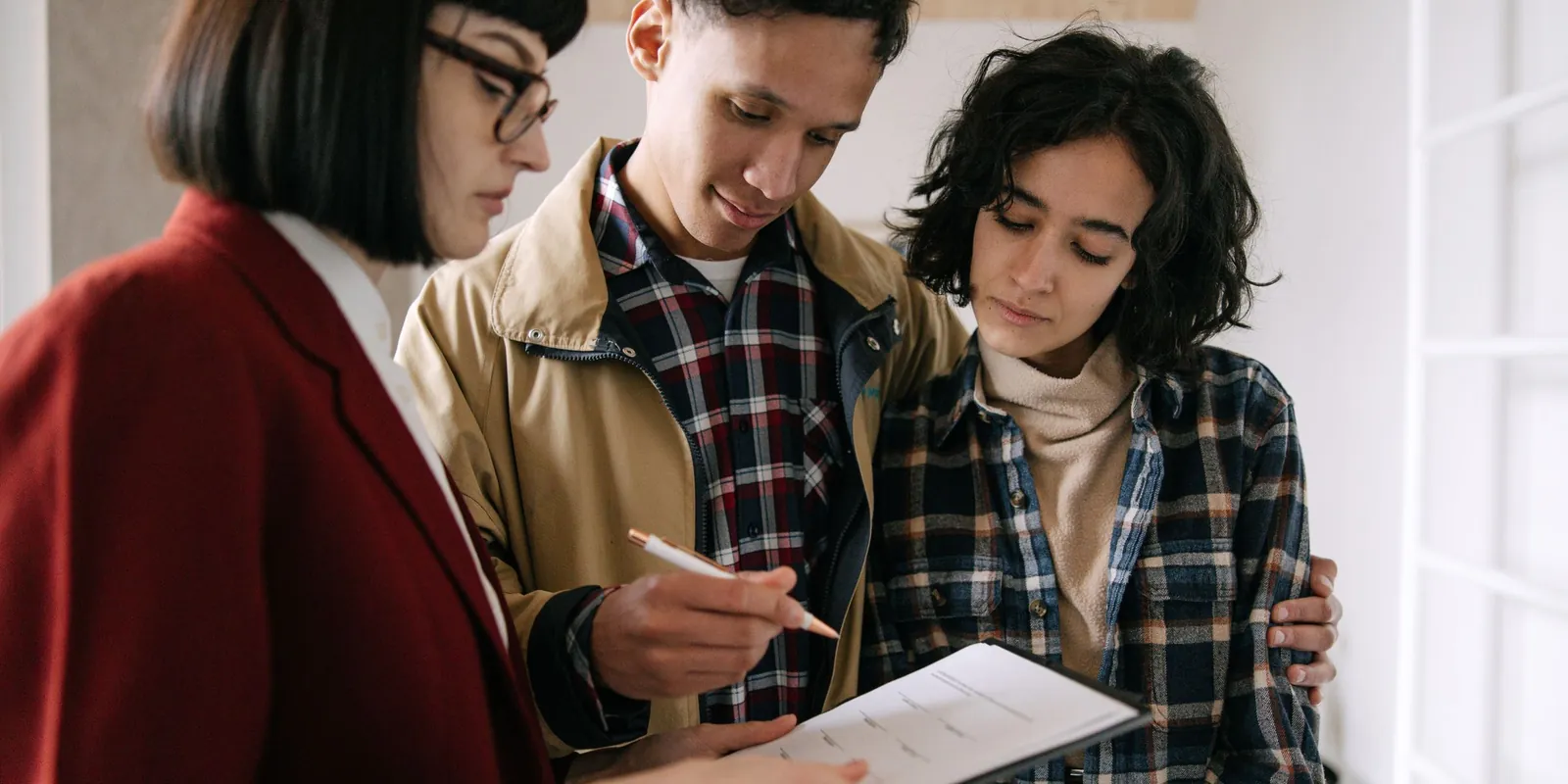 Couple reviewing property documents with a real estate agent
