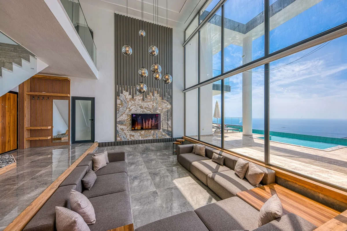 Bright villa living room with large windows facing the sea